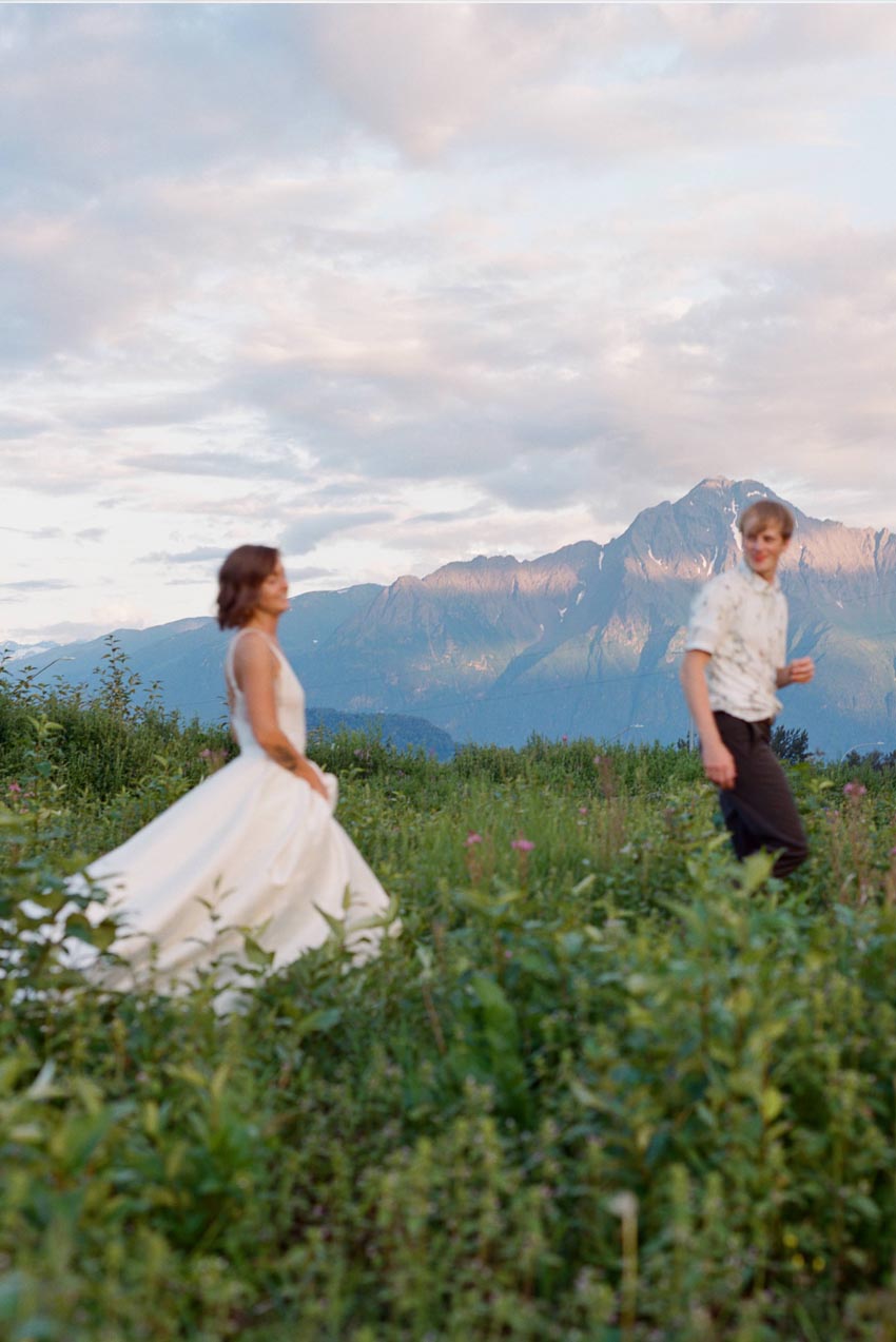 alaska farm wedding bride and groom in a field with mountains